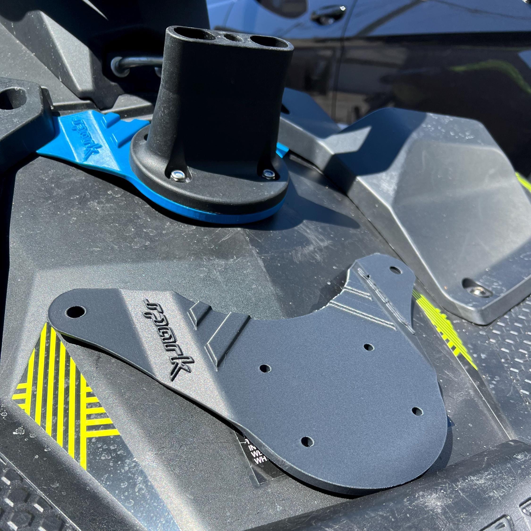 Black accessory mount and an unmounted gray gas can bracket resting on a Sea-Doo Spark deck