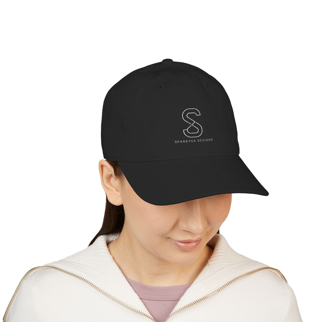 Woman wearing the Organic Embroidered Baseball Cap in Black, studio photo