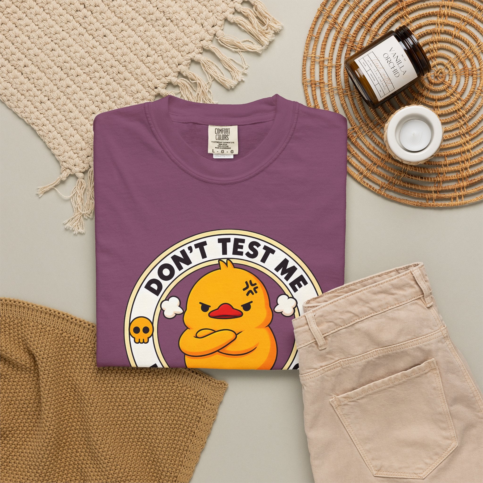 Dont Test Me Duck Tee in Berry — styled flat lay with props