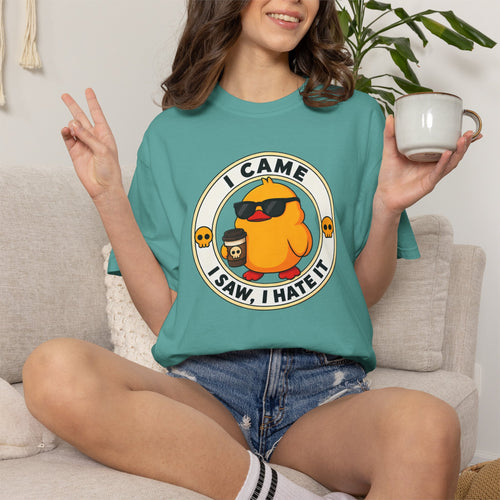 Woman wearing the I Came, I Saw, I Hate It Duck Tee in Seafoam, lifestyle photo holding a mug