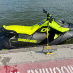 Yellow cup holder mounted on a docked Sea-Doo Spark Trixx, side view
