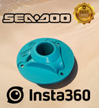 Close-up of a teal Sea-Doo Insta360 pole mount standing in sand at the beach