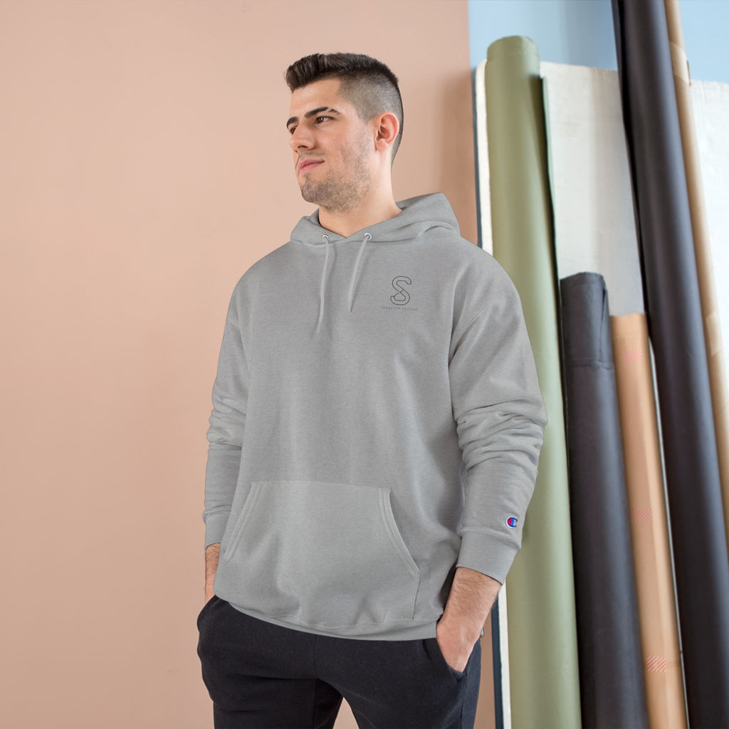 Man wearing the light steel grey SparkyCA Champion hoodie, hands in pockets