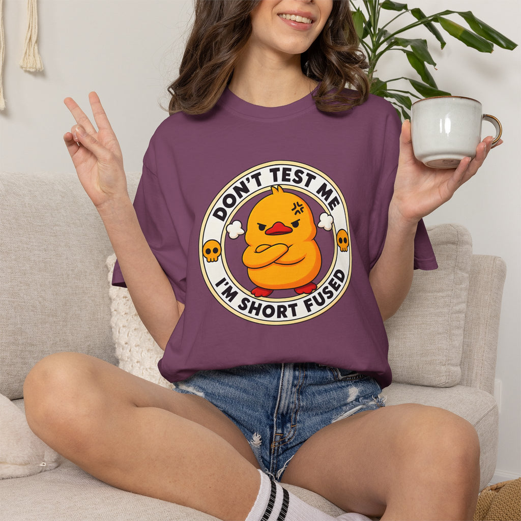 Woman wearing the Dont Test Me Duck Tee in Berry, lifestyle photo holding a mug