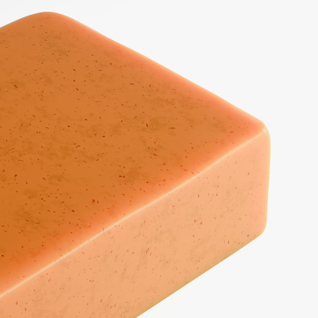 Close-up of the Kojic Acid & Turmeric Soap bar's textured orange surface with visible turmeric flecks