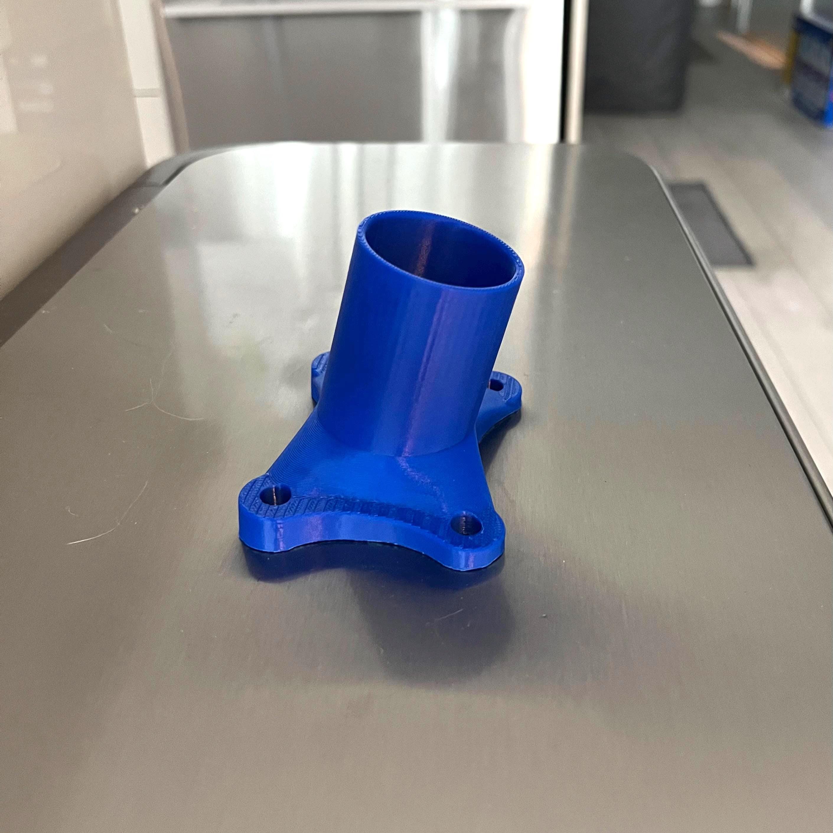 3D-printed flag/camera mount in blue plastic, standalone photo on a kitchen counter