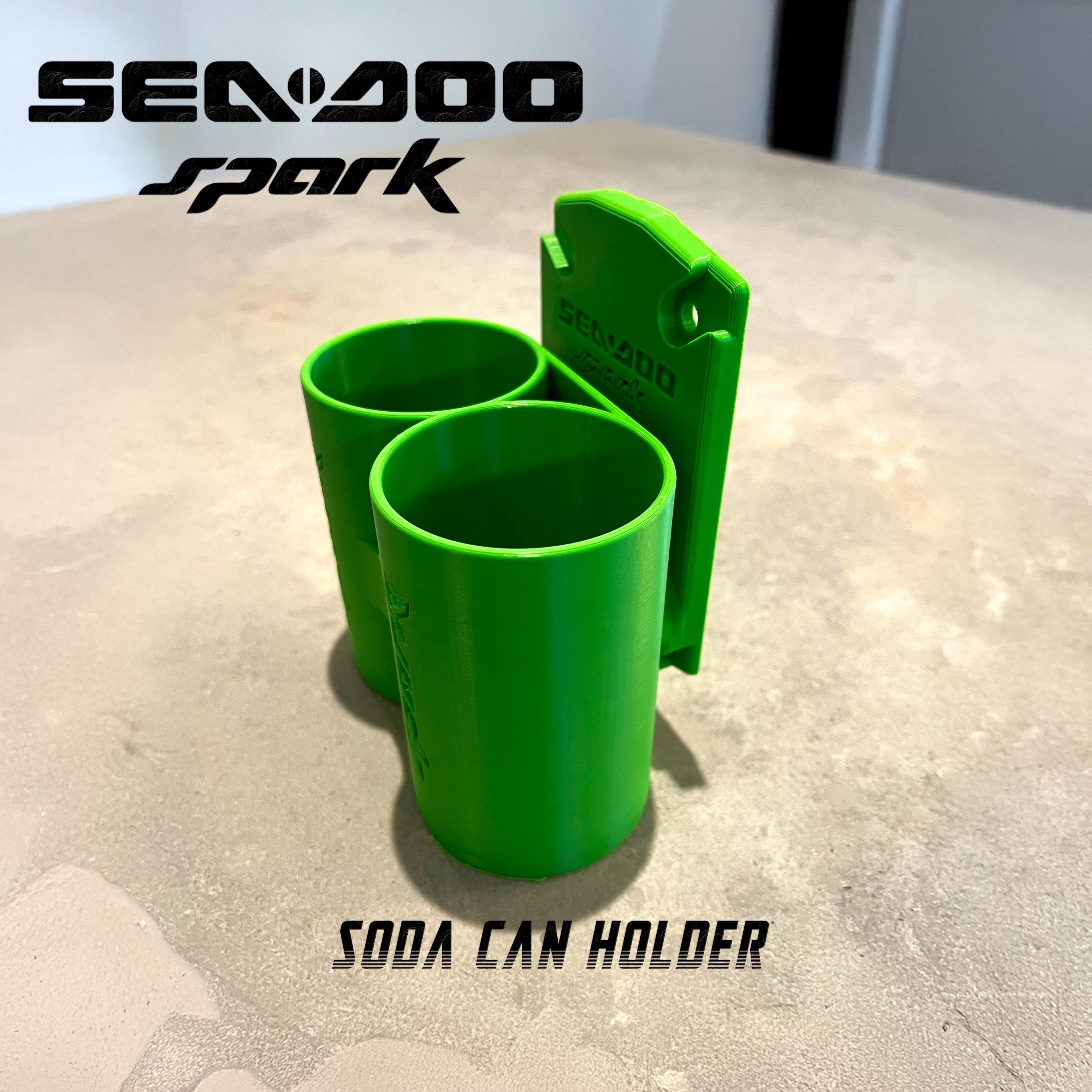 Green Sea-Doo Spark Trixx cup holder on a countertop, labeled soda can holder