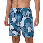 Blue and white hibiscus print swim shorts, front view on model