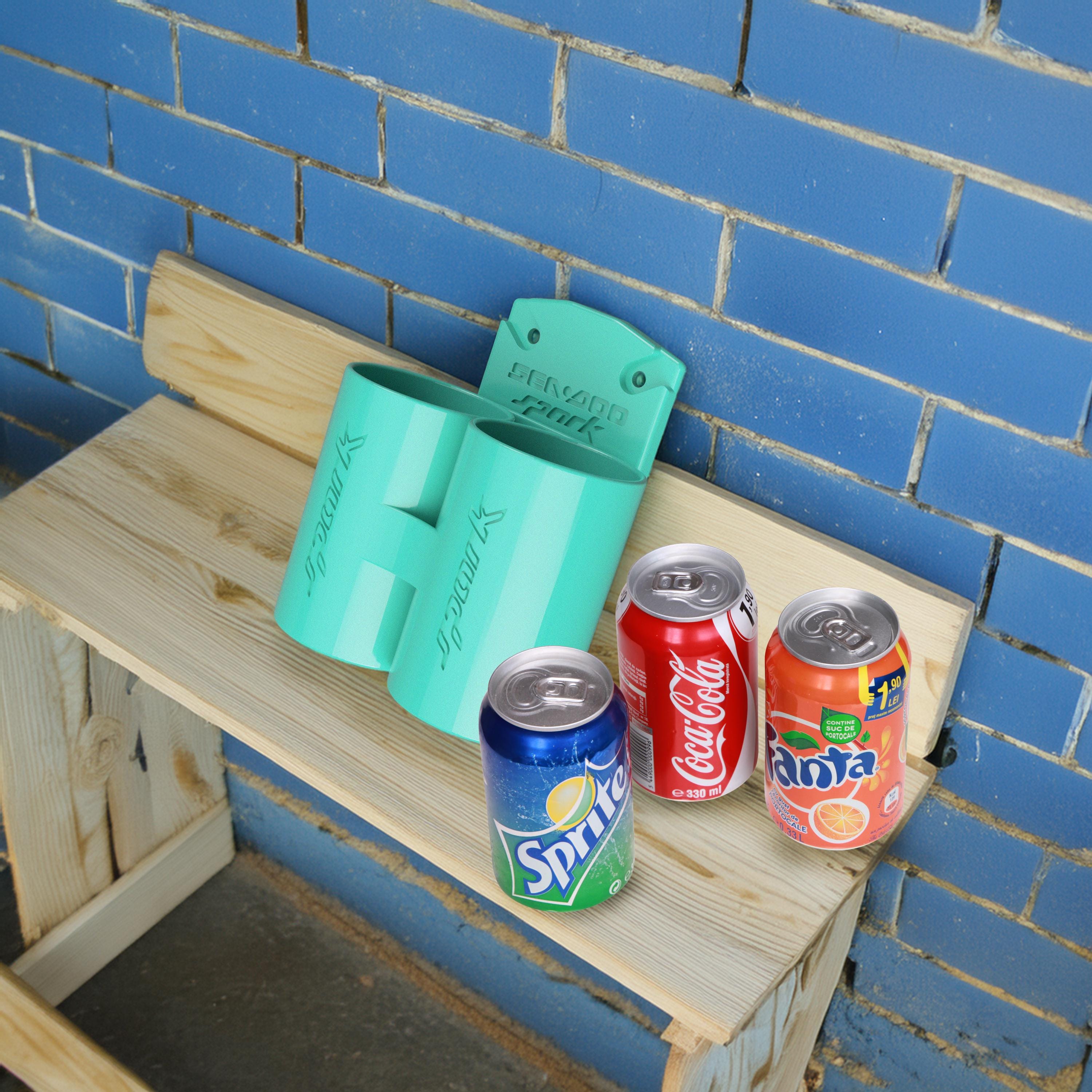 Teal Sea-Doo Spark Trixx cup holder displayed with soda cans for scale