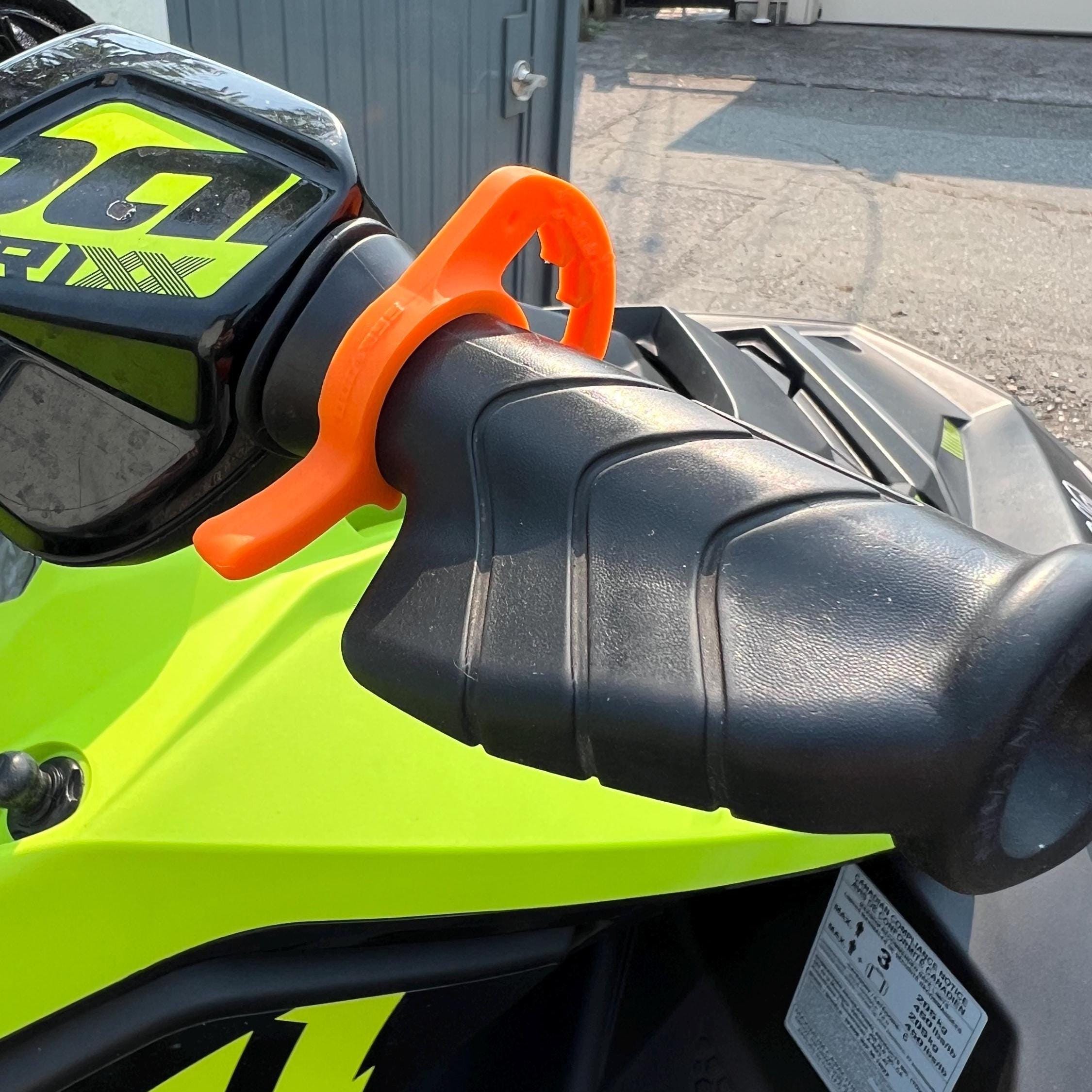 Orange cruise control lever on a Sea-Doo Spark Trixx handlebar