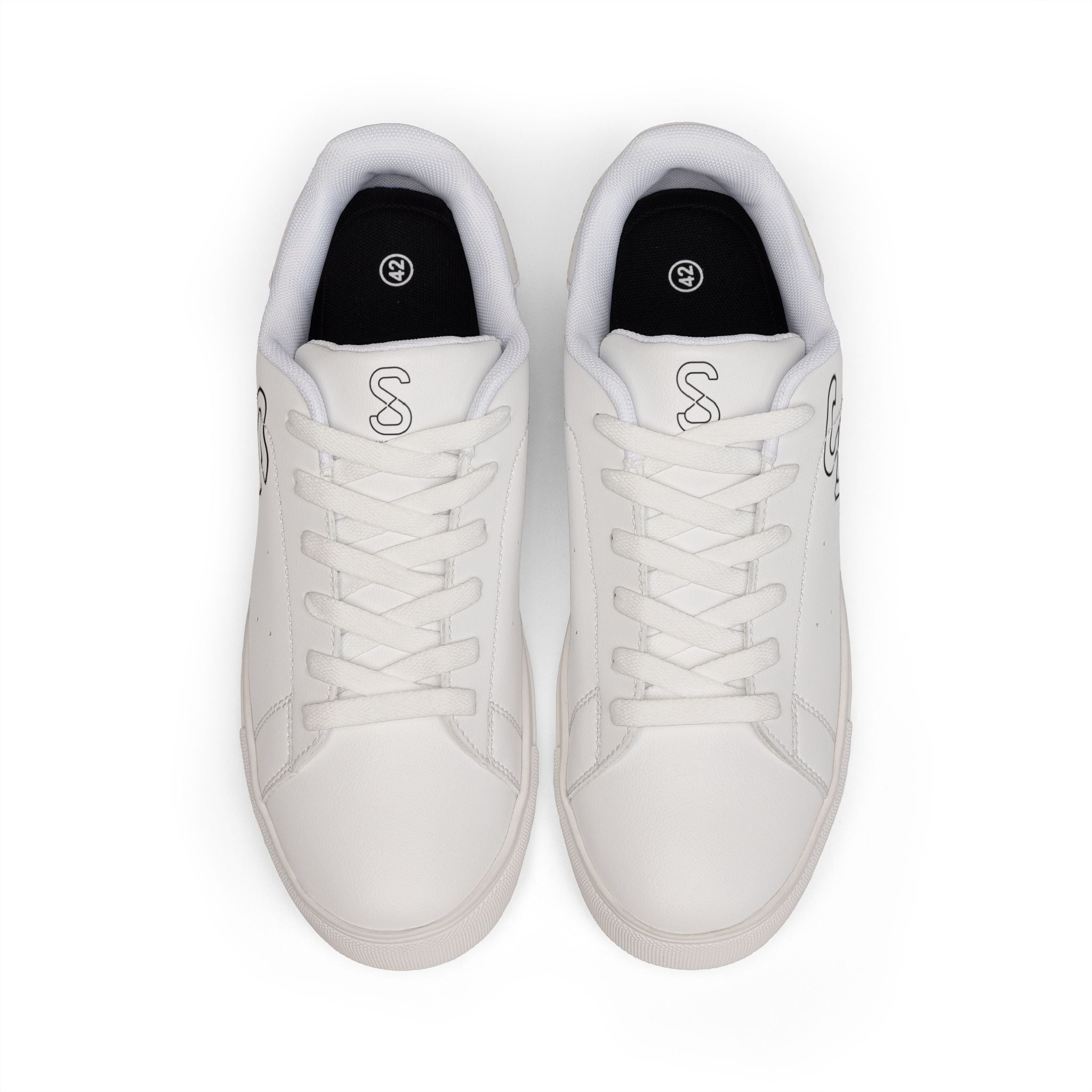 White leather sneakers, top-down view of the pair with black S logo on the tongue