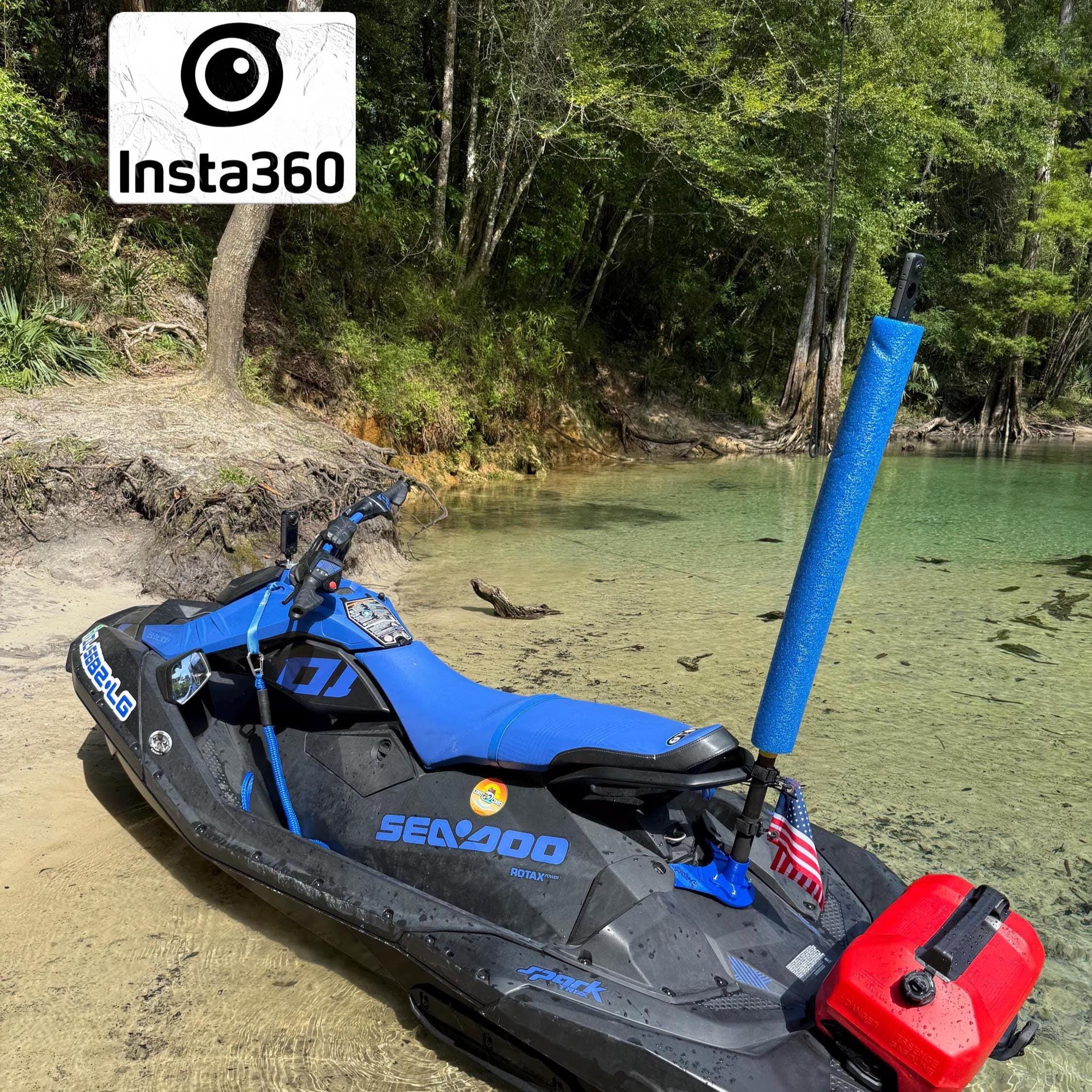 Sea-Doo Spark on a beach shoreline with the blue flag/camera mount and pole installed at the rear, Insta360 logo overlay