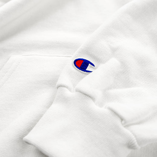 Close-up of the Champion logo patch on the hoodie's sleeve cuff