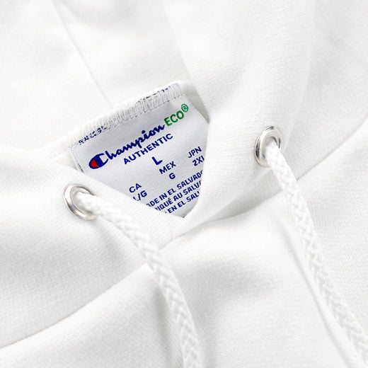 Close-up of the Champion Eco Authentic label and hood drawstring grommets
