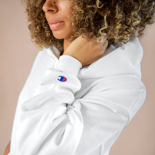 Close-up of the Champion logo patch on the hoodie's hood and neckline