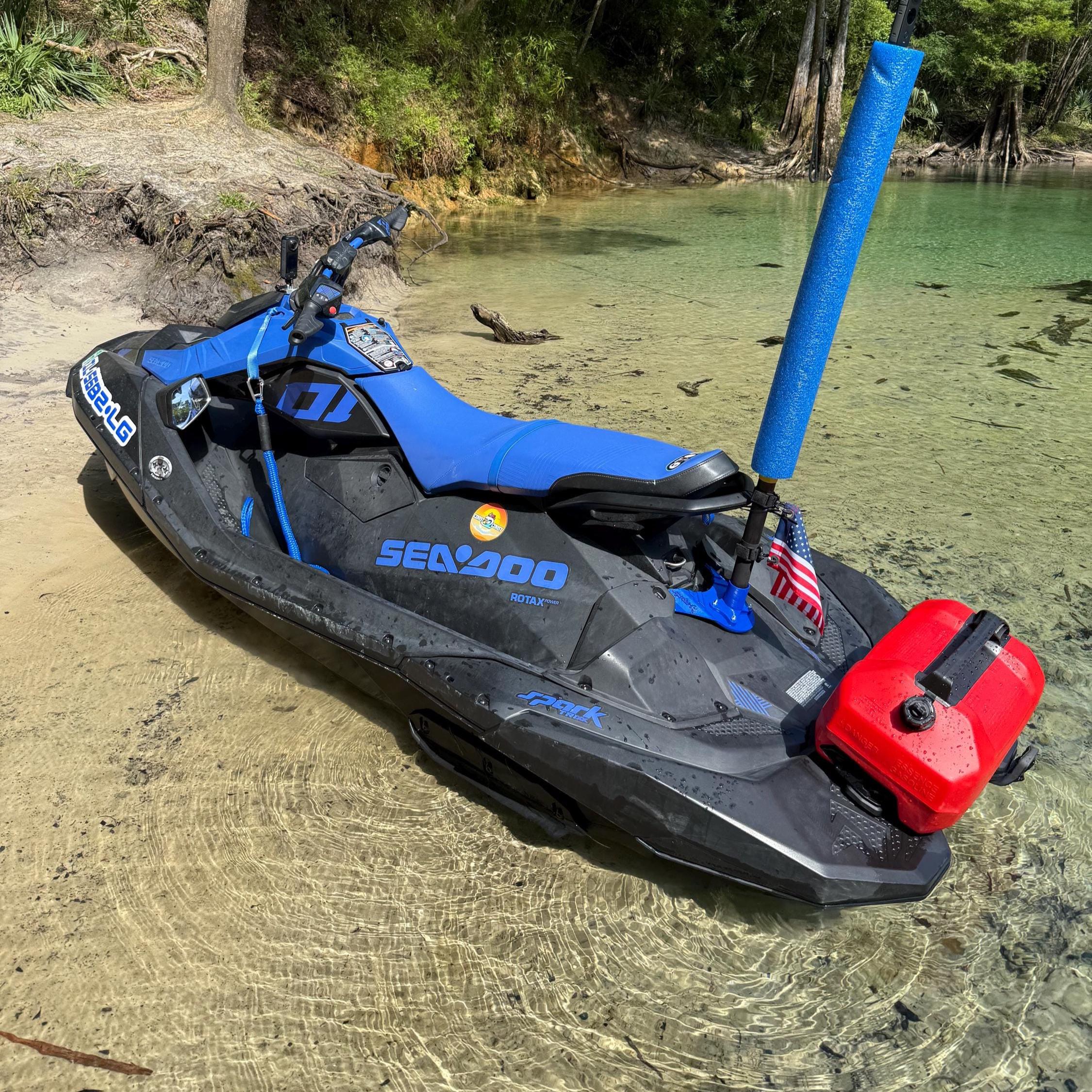 Sea-Doo Spark on a shallow beach shoreline, flag pole and mount visible at the rear next to the red fuel can