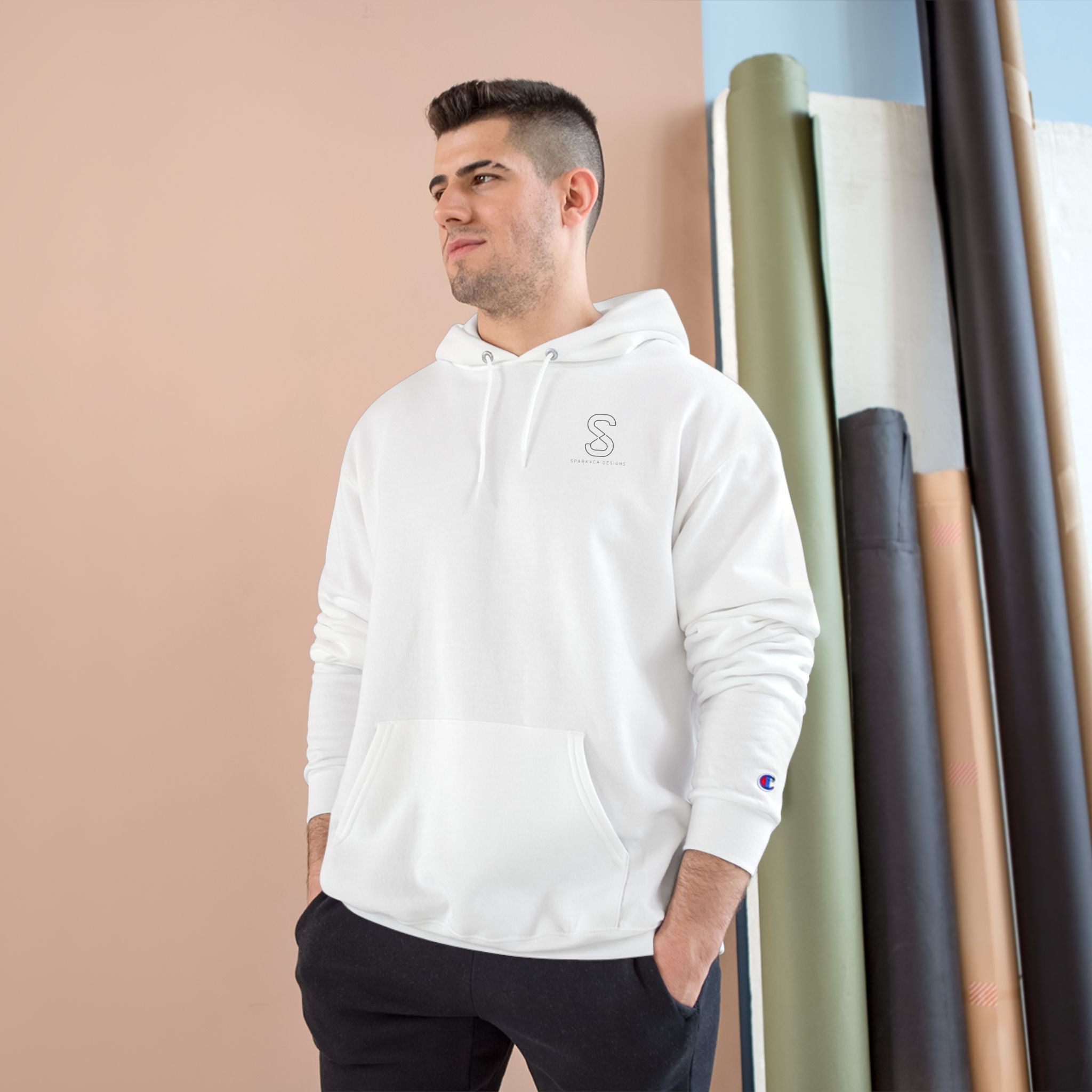 Man wearing the white SparkyCA Champion hoodie, hands in pockets