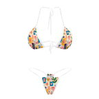 White-trim bikini set with colorful patchwork print, laid flat, top and bottom