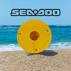Yellow Sea-Doo Insta360 pole mount standing upright on a beach with ocean in the background