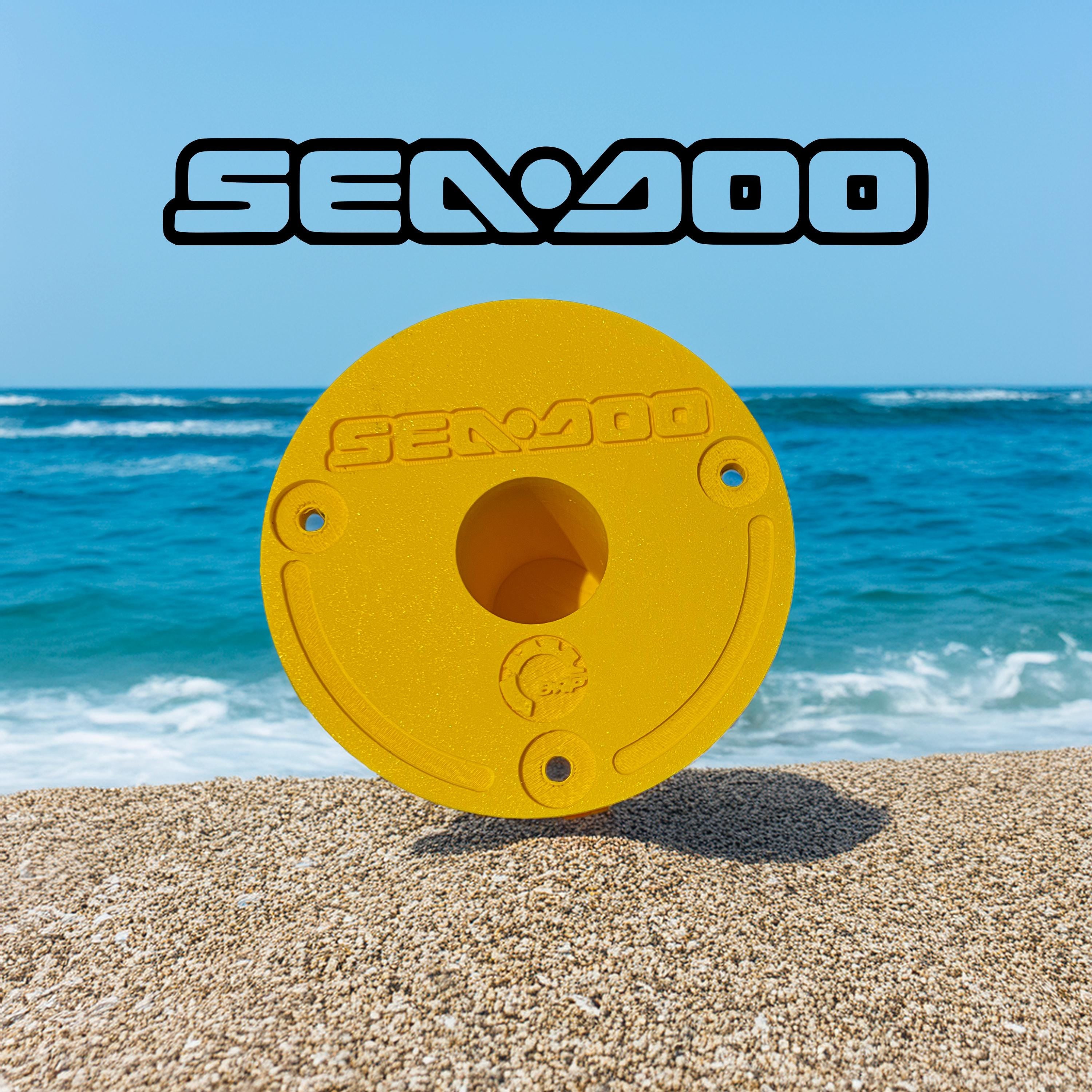 Yellow Sea-Doo Insta360 pole mount standing upright on a beach with ocean in the background