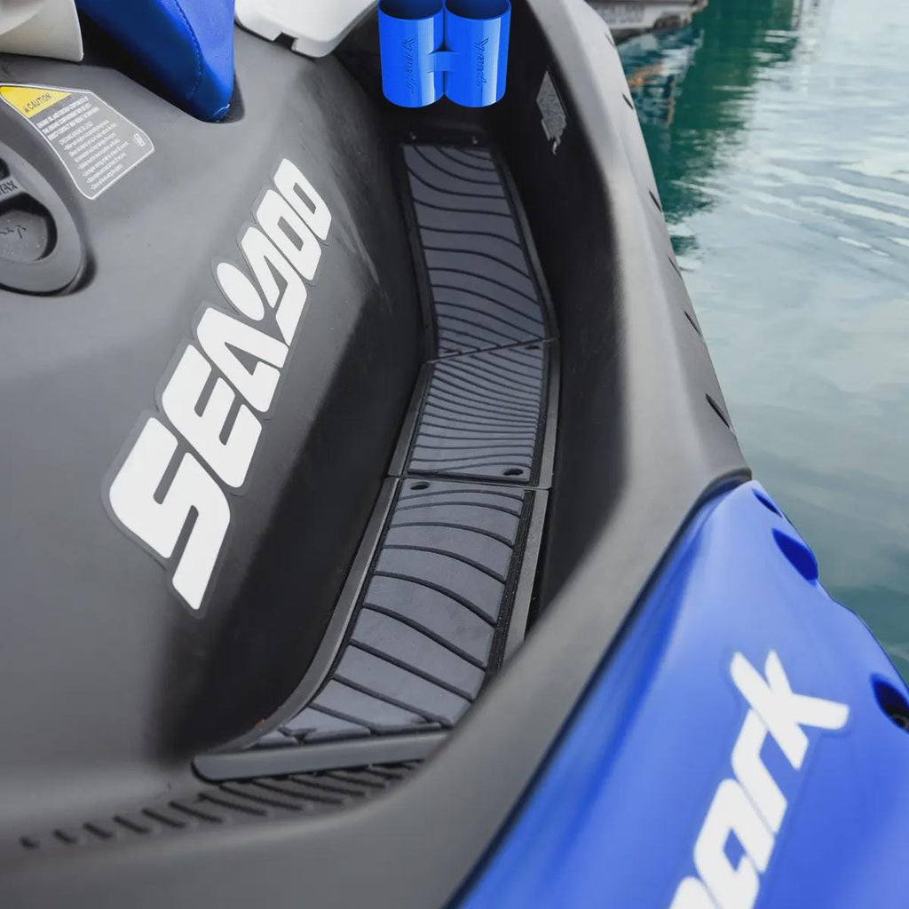 Blue cup holder mounted on the rear deck of a blue Sea-Doo Spark Trixx at a marina