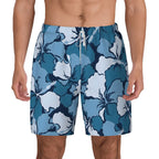 Blue and white hibiscus print swim shorts, front view close-up on model