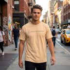 Man wearing tan SparkyCA t-shirt on a city street