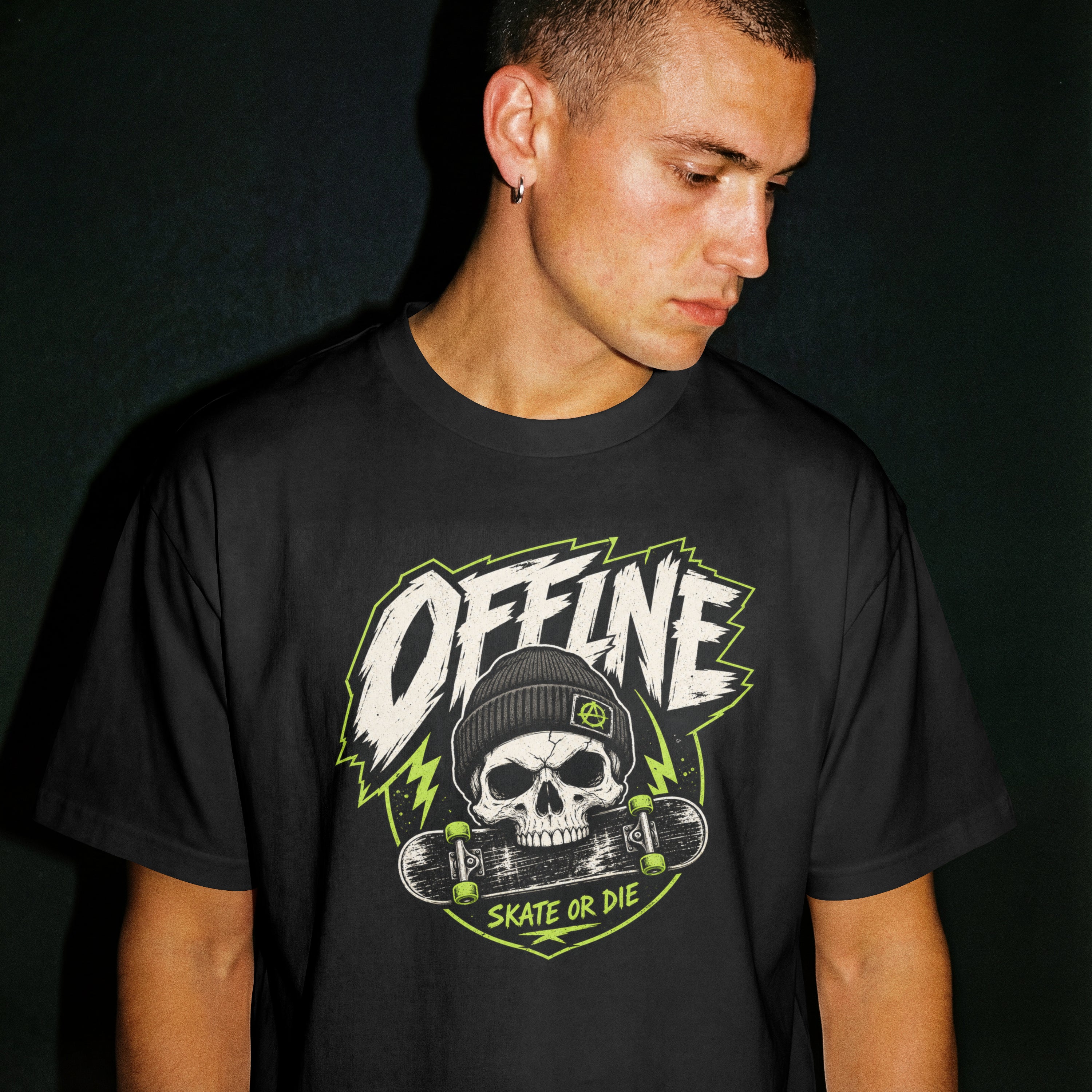 Man wearing a black Offline Skate or Die graphic tee, close-up on the crew neckline and skull-and-skateboard chest print.