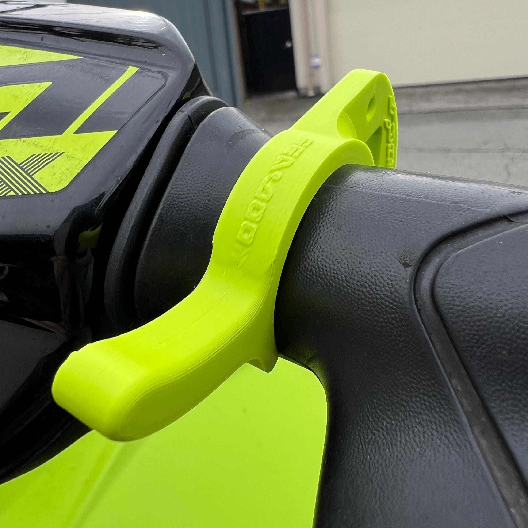 Close-up of lime green cruise control lever clipped onto handlebar