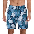 Men's swim shorts in blue and white hibiscus print, close-up front view on model