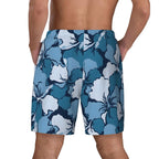 Blue and white hibiscus print swim shorts, back view on model