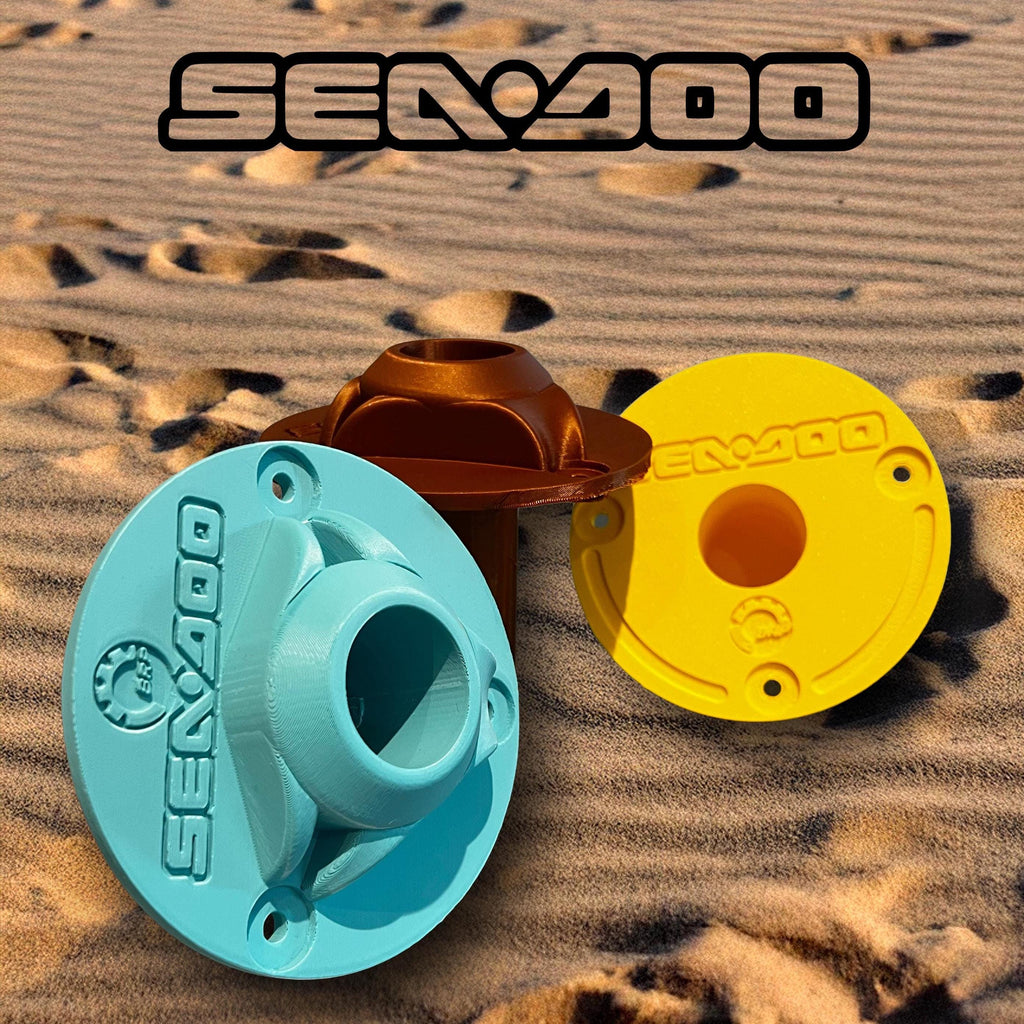 Bronze, teal, and yellow Sea-Doo Insta360 pole mounts grouped together on sand