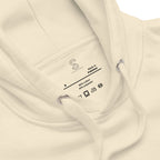 Close-up of the Bone hoodie's inner neck label showing the SparkyCA Designs logo, size, and made-in-Pakistan fabric tag