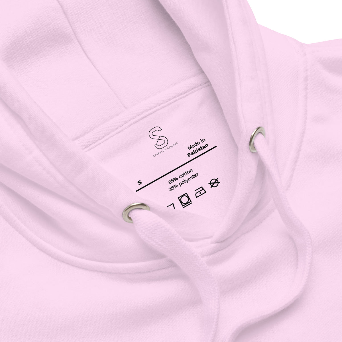 Close-up of the Lavender hoodie's inner neck label showing the SparkyCA Designs logo, size, and made-in-Pakistan fabric tag