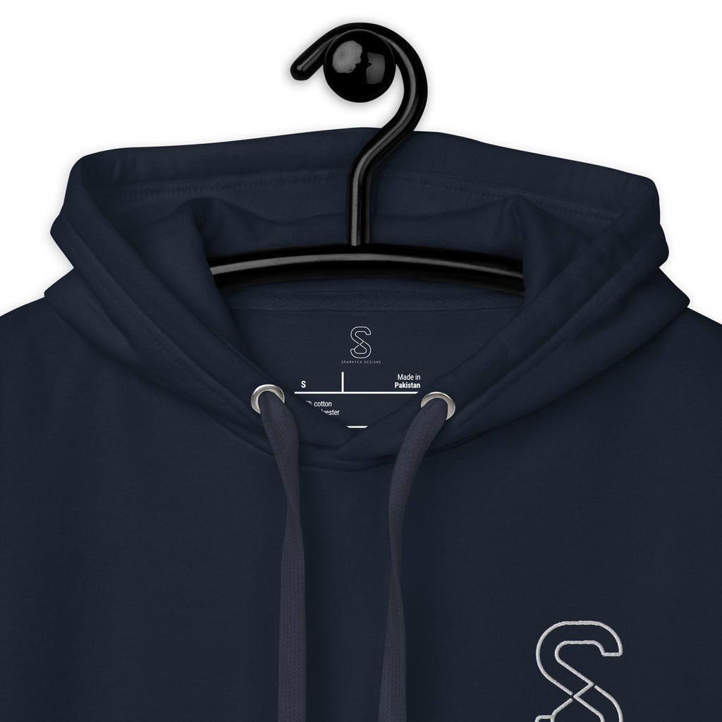 Close-up of the Navy Blazer hoodie's inner neck label showing the SparkyCA Designs logo, size, and made-in-Pakistan fabric tag