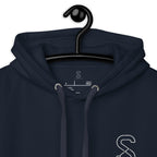 Close-up of the Navy Blazer hoodie's inner neck label showing the SparkyCA Designs logo, size, and made-in-Pakistan fabric tag