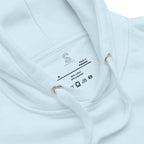 Close-up of the Sky Blue hoodie's inner neck label showing the SparkyCA Designs logo, size, and made-in-Pakistan fabric tag