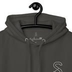 Close-up of the Vintage Black hoodie's inner neck label showing the SparkyCA Designs logo, size, and made-in-Pakistan fabric tag
